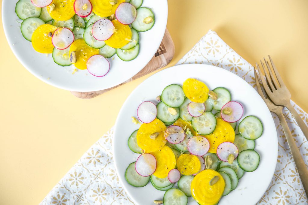 Two plates of golden beet and cucumber salad